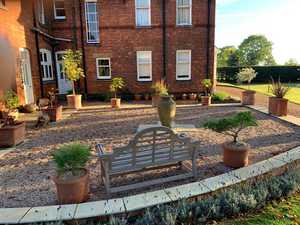 wooden bench and pots on gravel