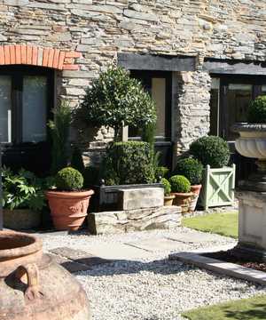 terracotta pots on gravel with paving slabs